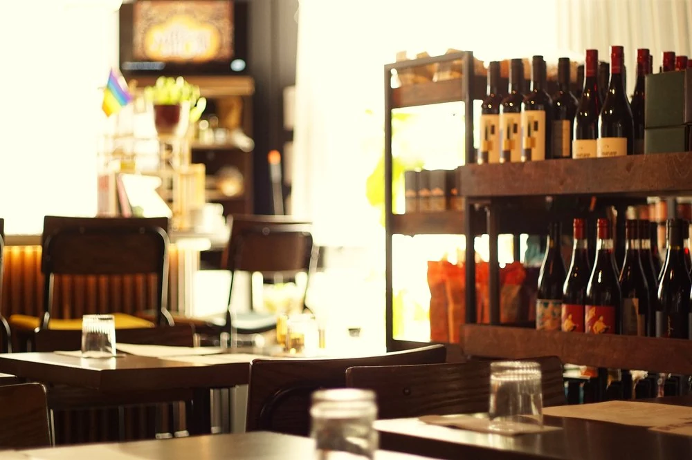 Tables and wine shelves inside Relish Bar & Market in Ritchie Market